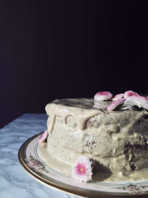 a healthyy carrot cake made with delicious ingredients, with a flowery decoration and a brown sugar & chamomile glaze